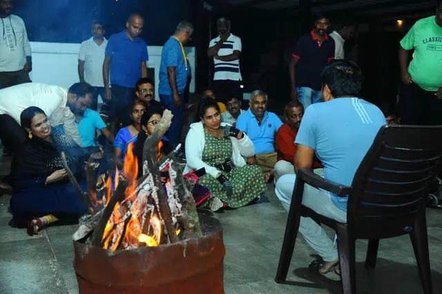 Participants around a campfire at night