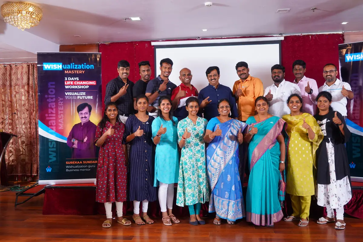 A batch of participants giving a thumbs up beside the WISHualization banners