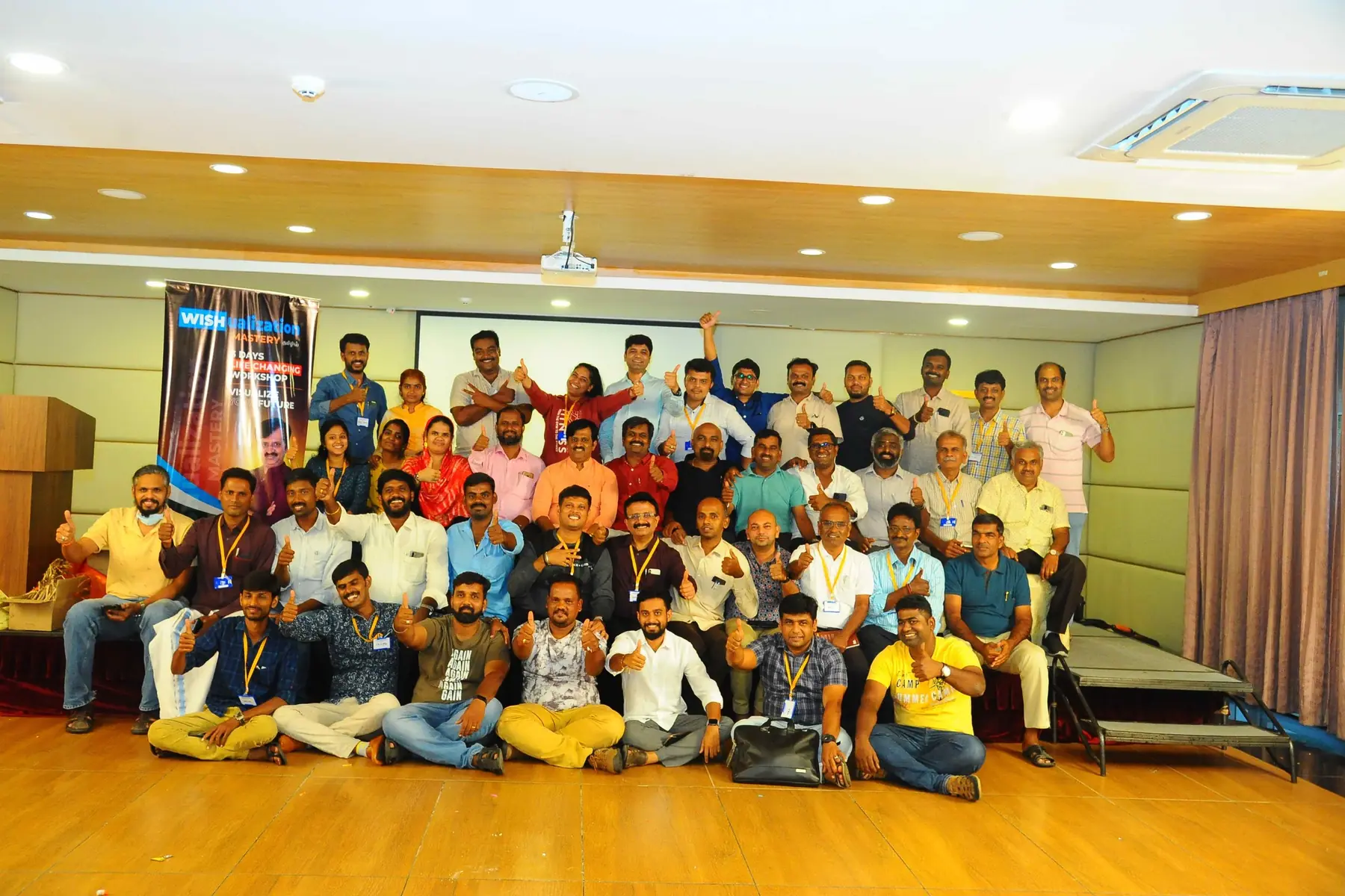 A full batch of participants giving a thumbs up