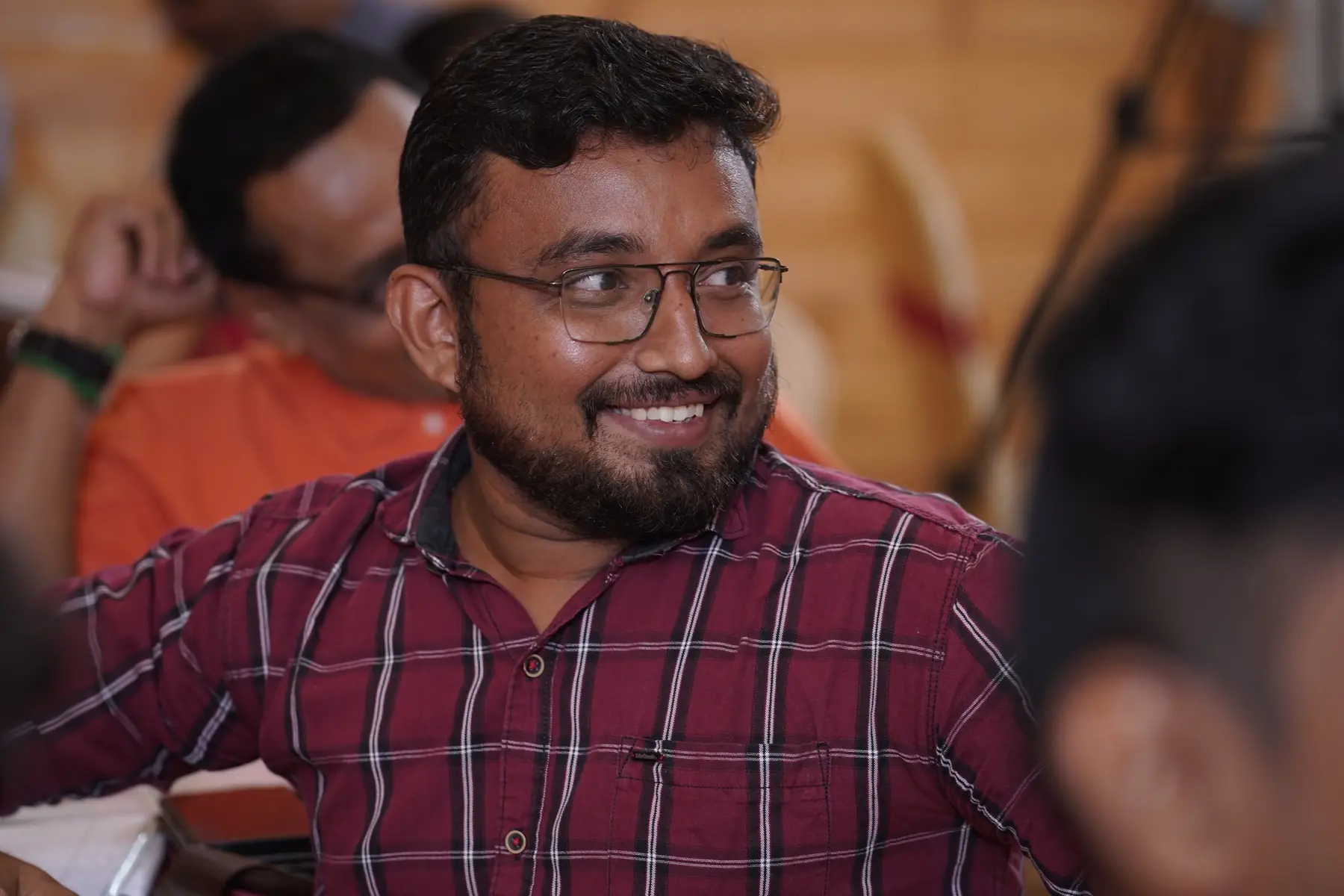 A participant smiling at his table