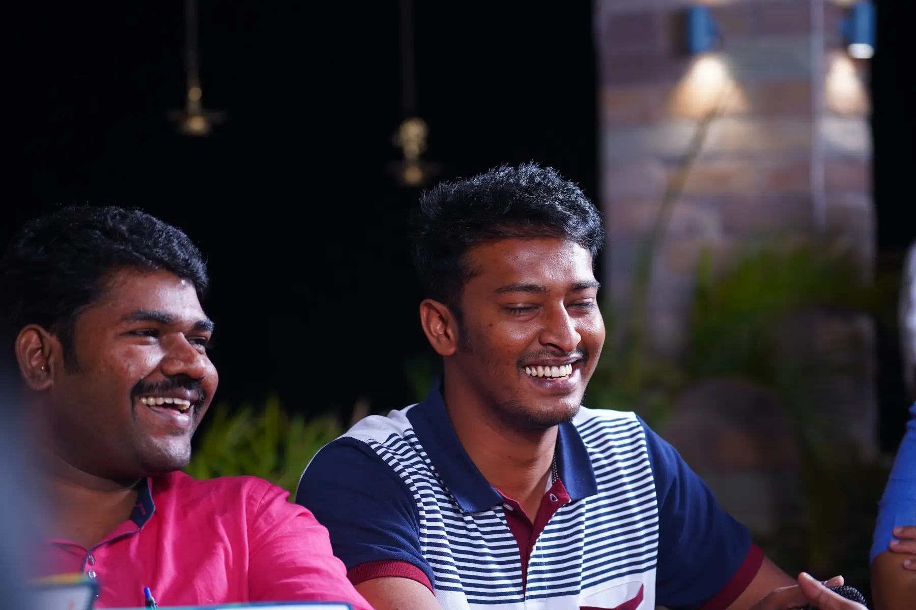 Two participants laughing at an evening session