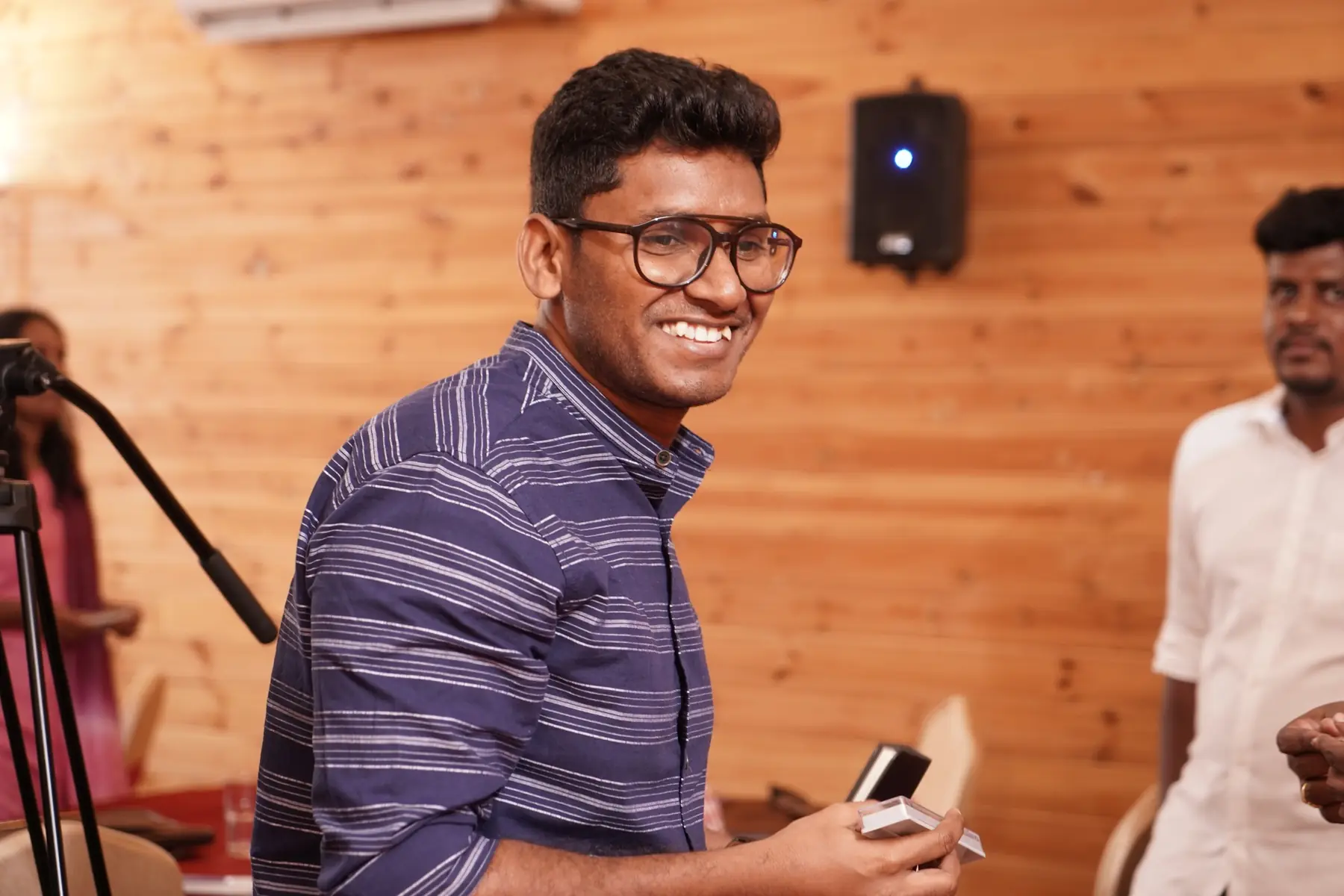 A participant in glasses, smiling