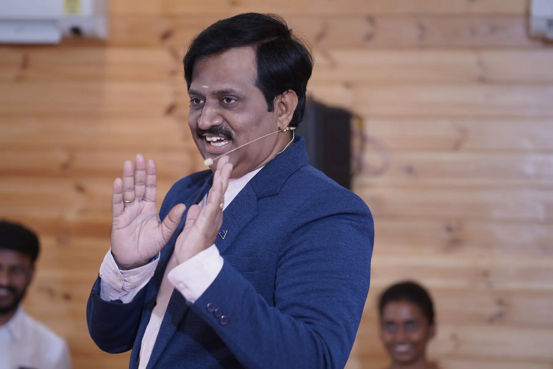 Surekaa Sundar in a suit, smiling as he speaks