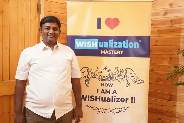 A participant beside the banner that reads Now I am a WISHualizer